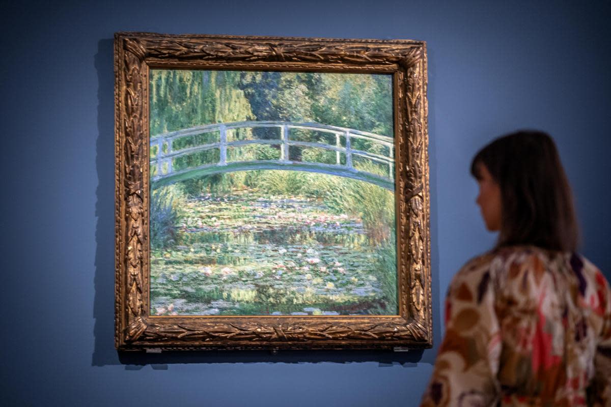 Dr Beatrice Bertram with Monet's 'The Water-Lily Pond' which will be on display at York Art Gallery from Friday <i>(Image: Danny Lawson/PA Wire)</i>
