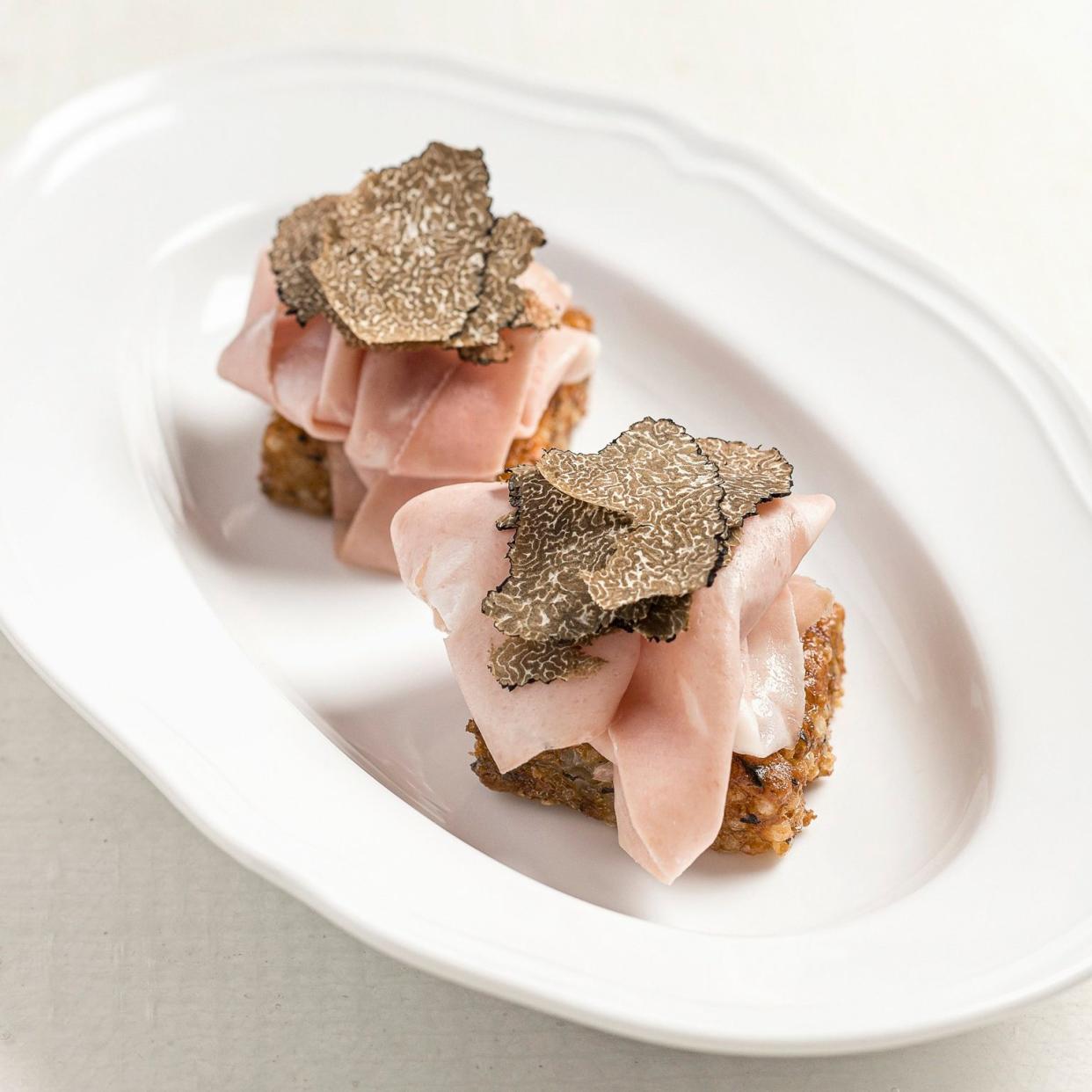 Mortadella on a crisp tapioca base with a shaving of truffle