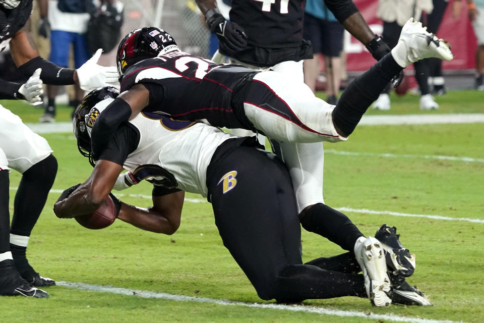 Baltimore Ravens tight end Isaiah Likely scores a touchdown as Arizona Cardinals safety Deionte Thompson (22) defends during the first half of an NFL preseason football game, Sunday, Aug. 21, 2022, in Glendale, Ariz. (AP Photo/Darryl Webb)