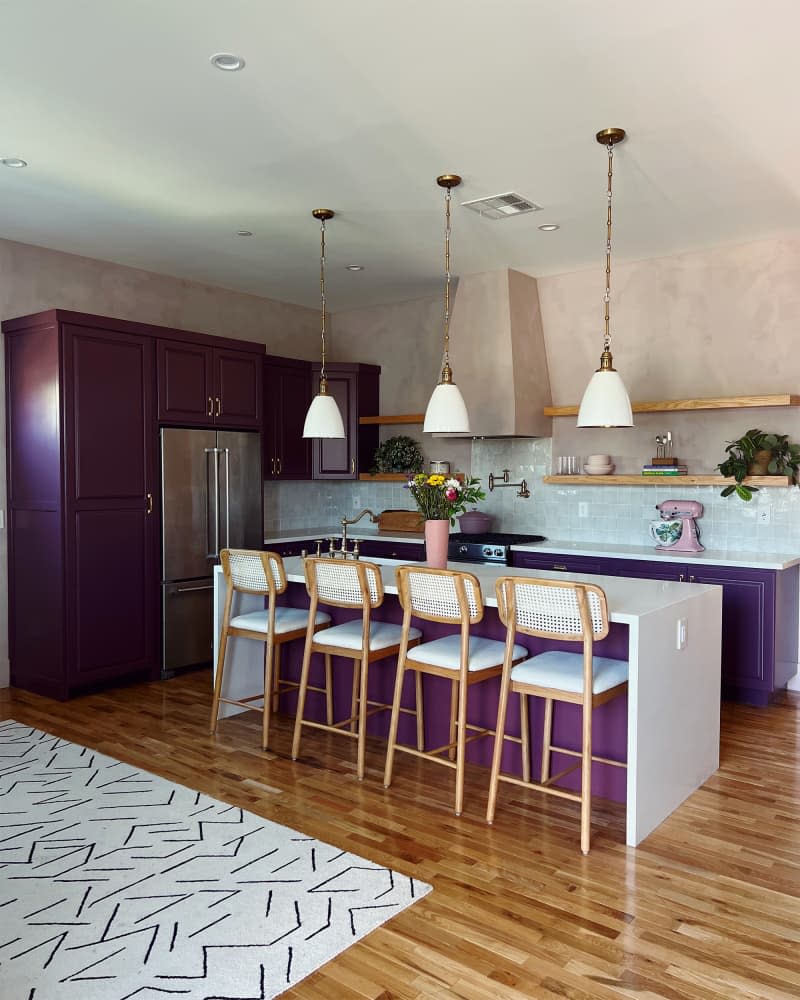 Eggplant painted cabinets in kitchen with light pink painted walls.