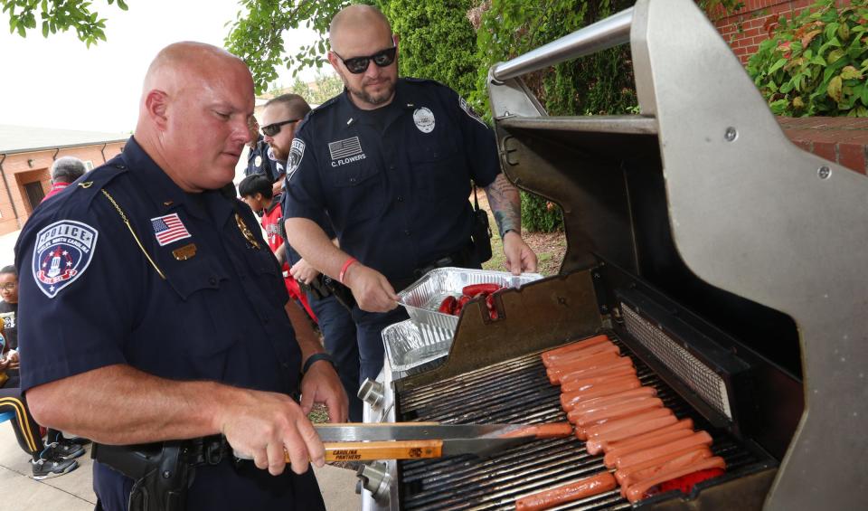 Shelby Police officers Lt. Scott Brown and Lt. Chris Flowers cook hot dogs during a reading celebration held Friday, May 13, 2022, at Shelby Intermediate School on South Post Road.