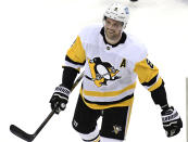 Pittsburgh Penguins defenseman Brian Dumoulin smiles after scoring a goal during the first period of the team's NHL hockey game against the New Jersey Devils on Friday, April 9, 2021, in Newark, N.J. (AP Photo/Bill Kostroun)