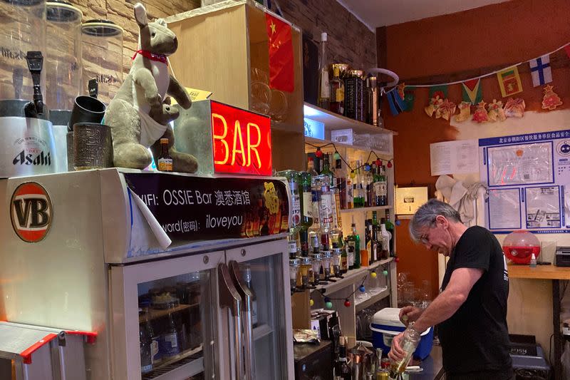 Steve Goodey, owner of the Ossie Bar and Restaurant, prepares a drink in Beijing