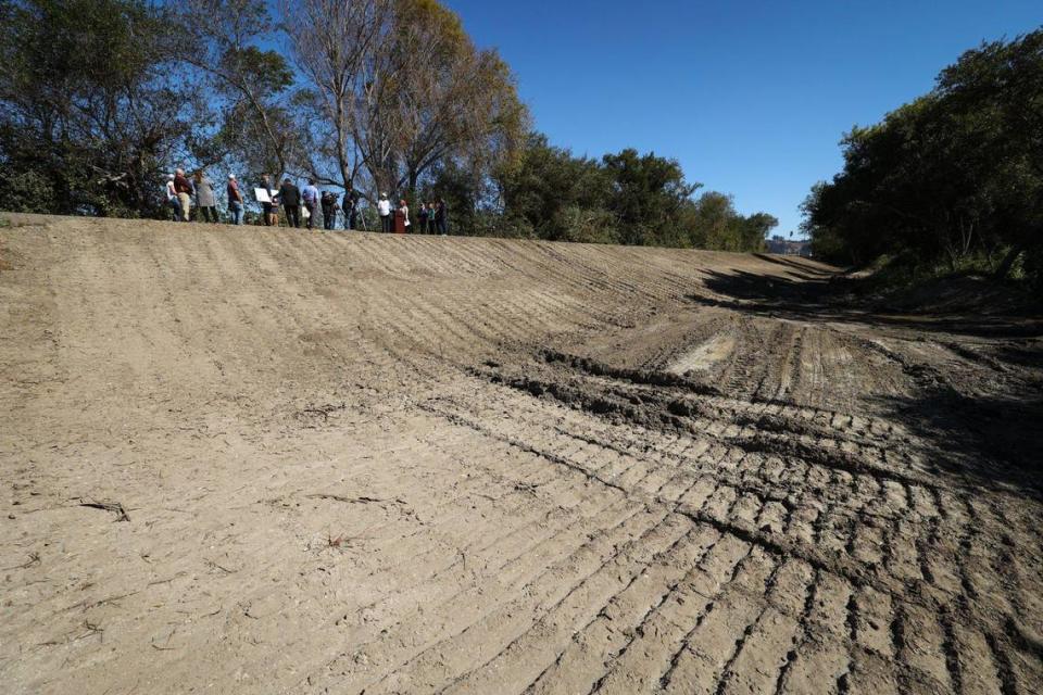 Work is underway to remove 11,000 cubic yards of sedediment while retaining habitat.Officials gathered to update the community on repairs to the Arroyo Grande Creek levee in Oceano Oct. 11, 2023.