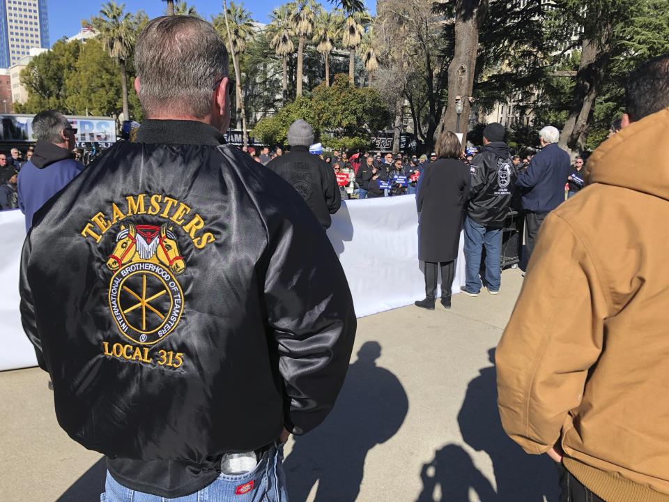 Joe Garner, a truck driver and shop steward for the local 315 of the International Brotherhood of Teamsters, watches a rally at the California Capitol on Monday, Jan. 30, 2023, in Sacramento, Calif. Garner supports a bill that would require human drivers to be present for self-driving semitrucks. (AP/Adam Beam)