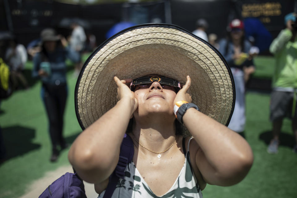 People watch a "ring of fire" solar eclipse in Tatacoa Desert, Colombia, Saturday, Oct. 14, 2023. The annular eclipse dimmed the skies over parts of the western U.S. and Central and South America. (AP Photo/Ivan Valencia)
