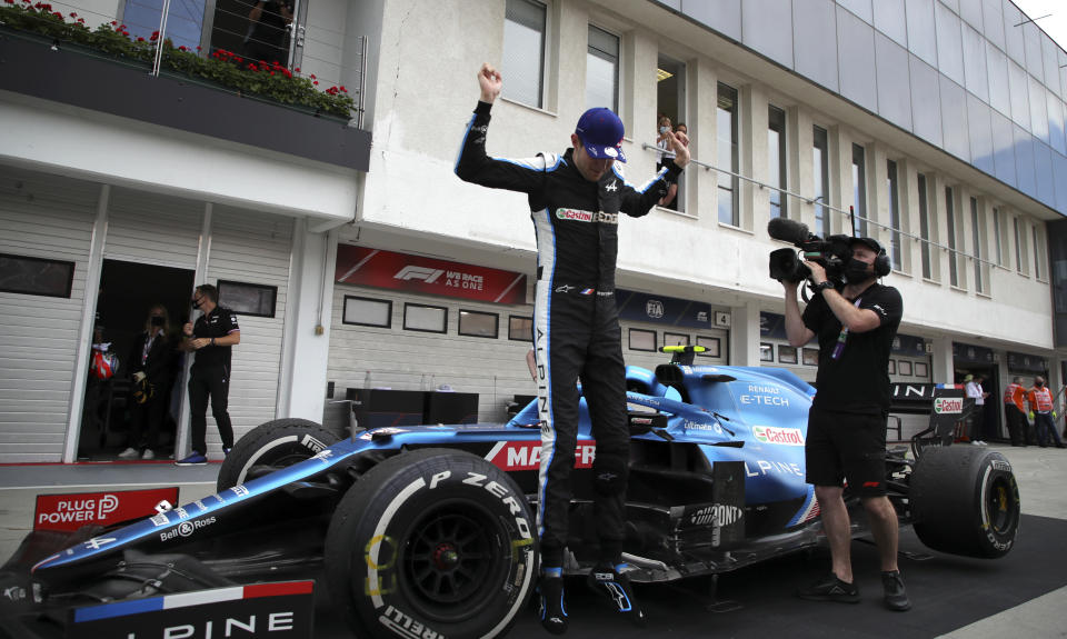 Alpine driver Esteban Ocon of France celebrates with his team after winning the Hungarian Formula One Grand Prix at the Hungaroring racetrack in Mogyorod, Hungary, Sunday, Aug. 1, 2021. (Florion Goga/Pool via AP)