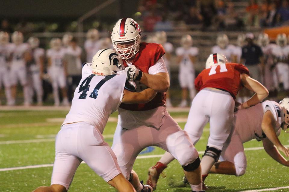 Henry County offensive tackle Luke Brown blocks a Summit defender during the first quarter of their high school football season opener Friday, Aug. 20, 2021 in Paris.