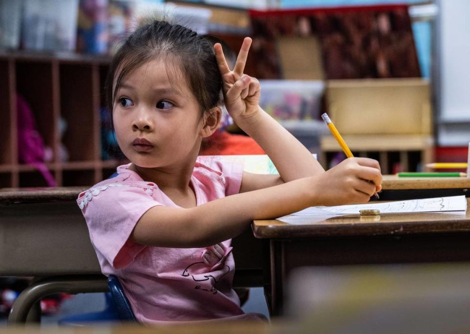 Carly Phu, 6, raises her hand on Tuesday, July 11, 2023, during the summer school Mandarin immersion program at William Land Elementary School in Southside Park. The school’s program is one of seven dual language immersion programs in the Sacramento City Unified School District.