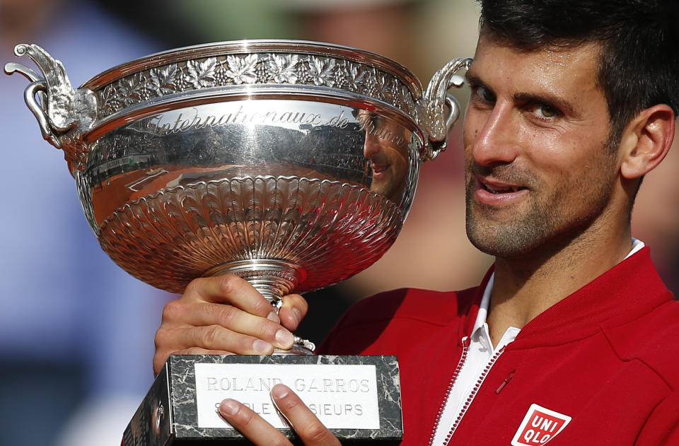 FILE - In this June 5, 2016, file photo, Serbia's Novak Djokovic holds the trophy after defeating Britain's Andy Murray in four sets 3-6, 6-1, 6-2, 6-4, in the finals of the French Open tennis tournament the Roland Garros stadium in Paris, France. (AP Photo/Christophe Ena, File)