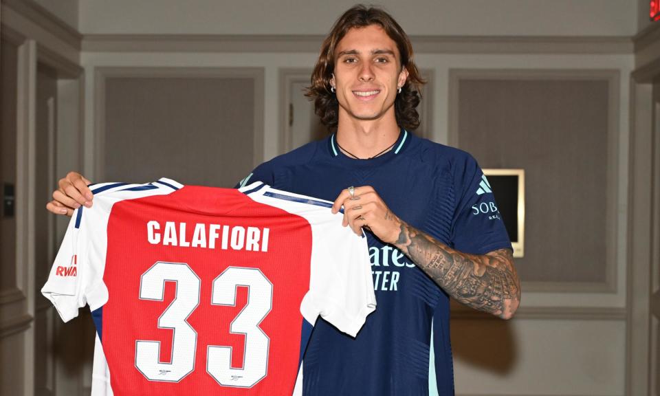 <span>Riccardo Calafiori poses with his Arsenal shirt after joining from Bologna for a fee believed to be an initial £33.6m.</span><span>Photograph: Stuart MacFarlane/Arsenal FC/Getty Images</span>