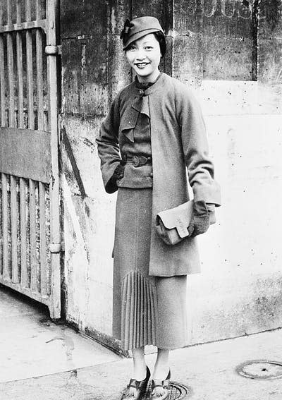 <span class="caption">Wong poses in front of the Hôtel de Crillon in Paris in 1935.</span> <span class="attribution"><a class="link " href="https://www.gettyimages.com/detail/news-photo/anna-may-wong-popular-chinese-film-star-pictured-in-front-news-photo/515607792?adppopup=true" rel="nofollow noopener" target="_blank" data-ylk="slk:Bettmann/Getty Images;elm:context_link;itc:0;sec:content-canvas">Bettmann/Getty Images</a></span>