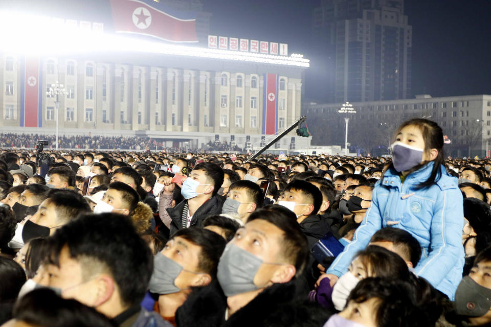 People gather during national flag hoisting ceremony on Kim Il Sung Square in Pyongyang, North Korea, Saturday, Jan. 1, 2022. (AP Photo/Cha Song Ho)