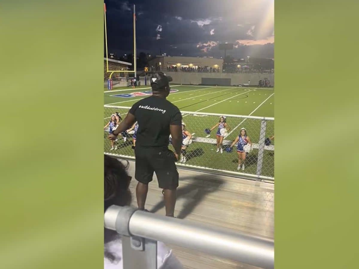 A father dances in the stands while his daughter’s cheerleading team performs  (TikTok)