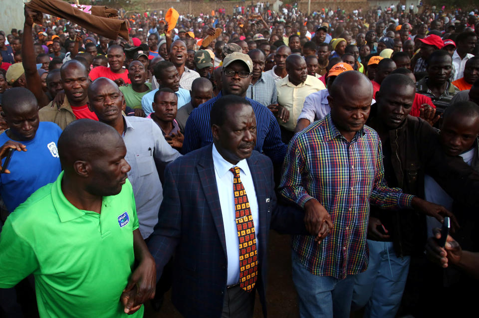 Kenyan opposition leader Raila Odinga (center) lost three successive elections&nbsp;to Uhuru Kenyatta, who had&nbsp;hired Cambridge Analytica. (Photo: Stringer / Reuters)
