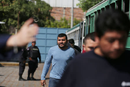 Deportees get off a bus at an immigration facility after a flight carrying illegal immigrants from the U.S. arrived in San Salvador, El Salvador, January 11, 2018. Picture taken January 11, 2018. REUTERS/Jose Cabezas