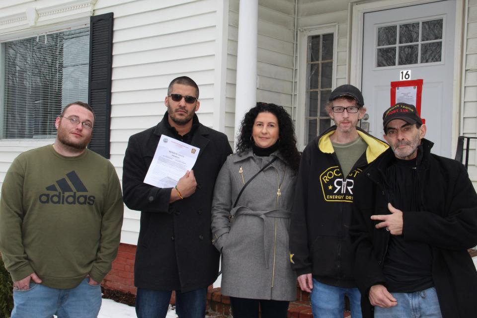 William Sylvia, Raymond Negron, Joanna Koszalka, Todd Farr, and Carlos Z at the Positive Transitions sober home at 16 Pine St. in Rochester Thursday, Dec. 30, 2021. Sylvia, Carlos and Farr are three of the men who were displaced by the cease-and-desist order issued by the city Dec. 28. Negron, the operations director, Koszalka, the owner, are married.