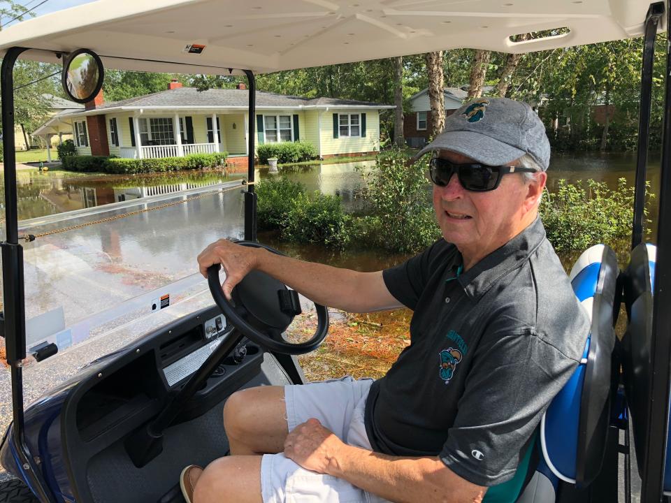 Joe Holmes rides his golf cart around neighborhoods to survey floodwaters in Conway, S.C., on Monday, Sept. 17, 2018. Holmes barely avoided the flooding in 1999 and 2016, but worries a decision by the state of South Carolina to build a higher wall on the main highway to Myrtle Beach to keep it open might finally push the floodwaters from the Waccamaw River into his house. The state says the effect will be negligible. (AP Photo/Jeffrey Collins)