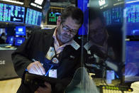 Trader James MacGilvray works on the floor of the New York Stock Exchange, Thursday, Oct. 14, 2021.Stocks are moving broadly higher in early trading on Wall Street as the market builds momentum a day after breaking a three-day losing streak. (AP Photo/Richard Drew)