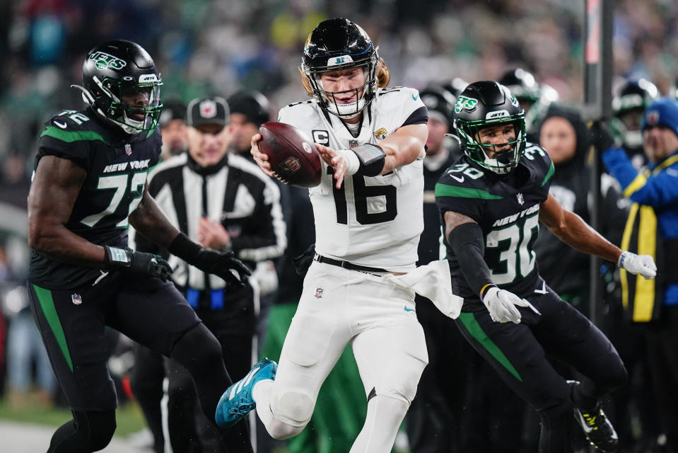 Jacksonville Jaguars quarterback Trevor Lawrence (16) tries to get the ball across the goal line as he steps out of bounds against the New York Jets during the second quarter of an NFL football game, Thursday, Dec. 22, 2022, in East Rutherford, N.J. (AP Photo/Frank Franklin II)