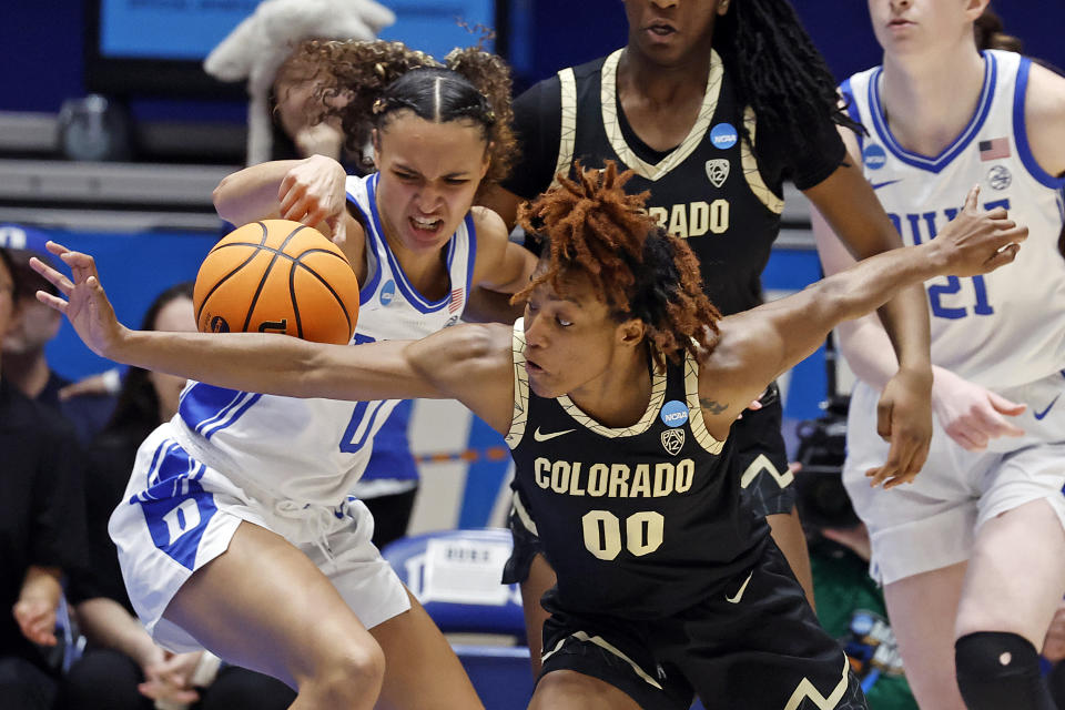 Colorado's Jaylyn Sherrod (00) causes Duke's Celeste Taylor (0) to lose control of the ball during the first half of a second-round college basketball game in the NCAA Tournament, Monday, March 20, 2023, in Durham, N.C. (AP Photo/Karl B. DeBlaker)