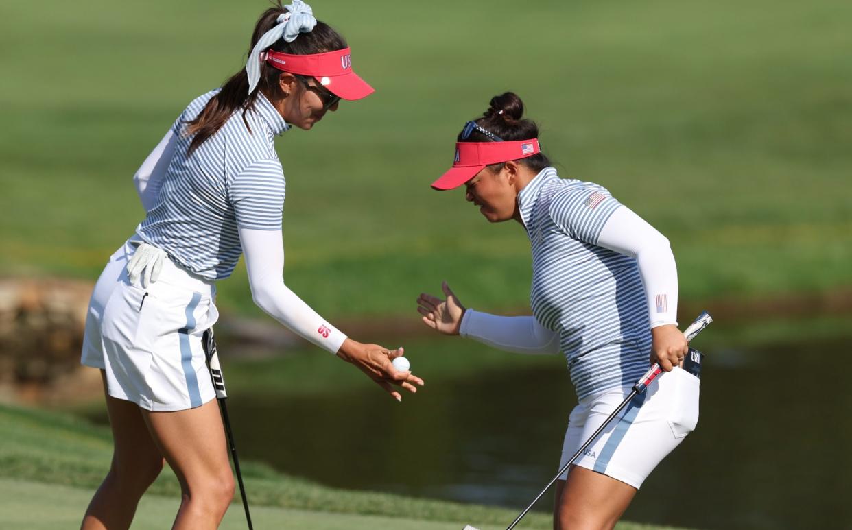 Megan Khang and Alison Lee celebrate an eagle