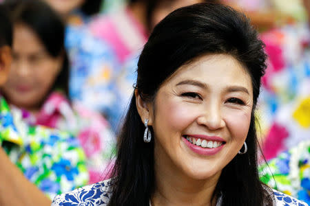 FILE PHOTO - Former Thai Prime Minister Yingluck Shinawatra smiles as she takes part in Songkran festival celebration with opposition Puea Thai party members at the party headquarters in Bangkok, Thailand, April 7, 2016. REUTERS/Athit Perawongmetha/File Photo