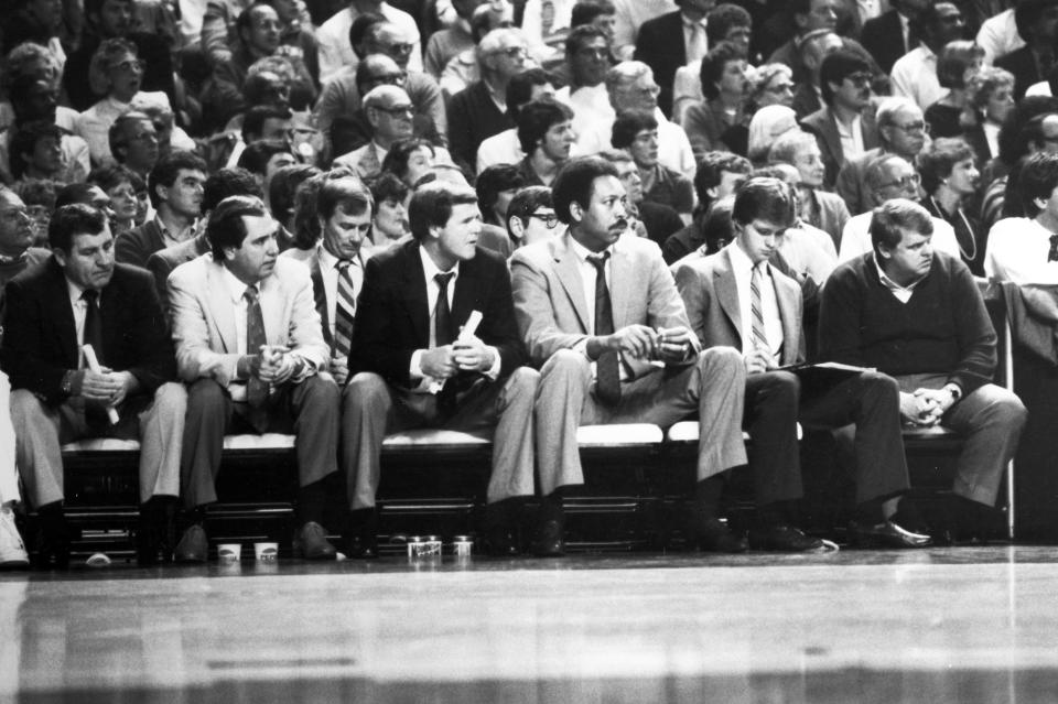 Jerry May, far right, the longtime assistant athletic director for sports medicine at the University of Louisville, sits on the bench with head coach Denny Crum and members of his staff during a men's basketball game. May died Sunday at age 72.