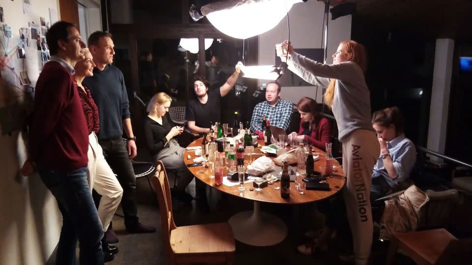 From left, Christo Grozev, Yulia Navalny, Alexey Navalny, Dasha Navalny, Daniel Roher, Georgy Alburov, Kira Yarmysh, Odessa Rae and Maria Pevchikh eat and unwind after 20 hours of filming the phone call and the CNN release. - Niki Waltl