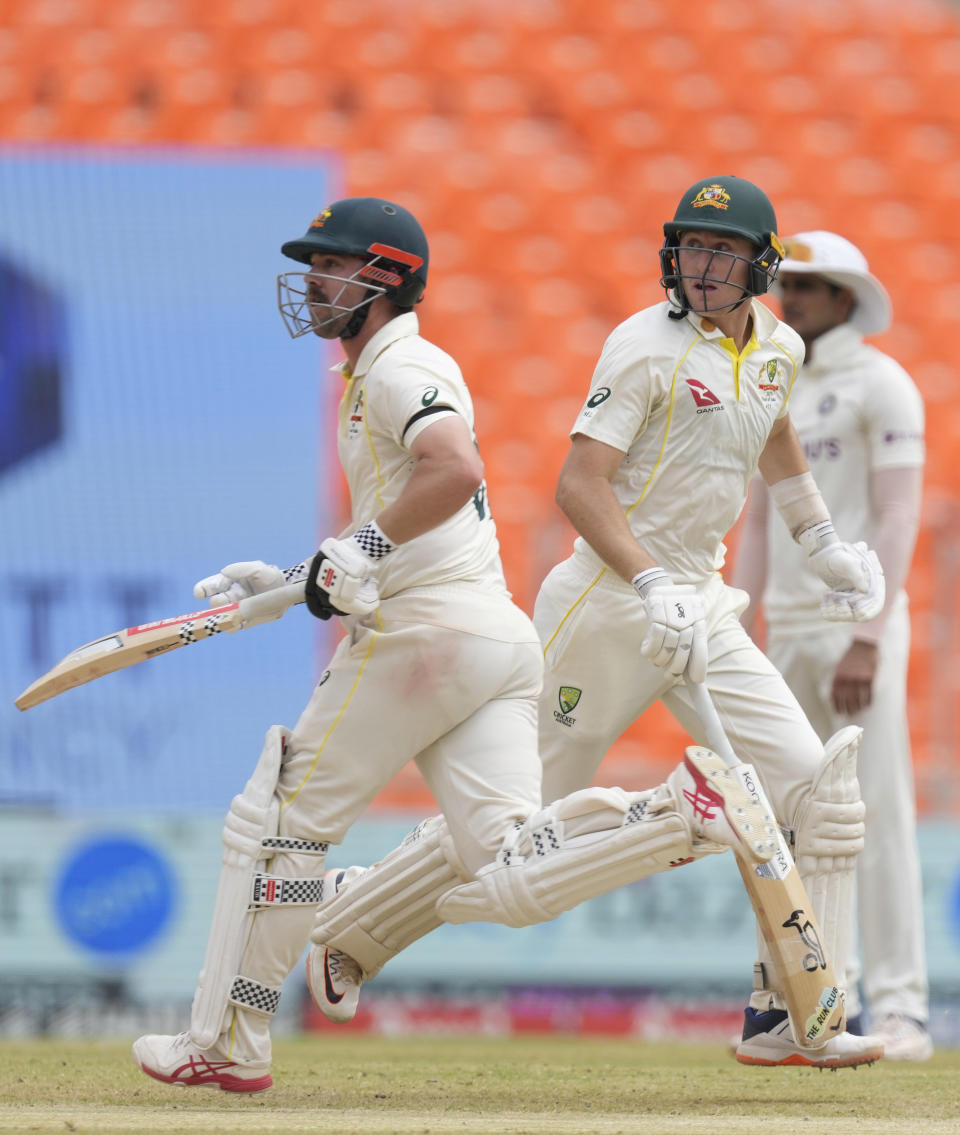 Australia's Travis Head, left, along with Australia's Marnus Labuschagne score a run during the fifth day of the fourth cricket test match between India and Australia in Ahmedabad, India, Monday , March 13, 2023. (AP Photo/Ajit Solanki)