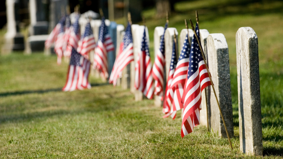 American Flags on tombstones in a cemetery