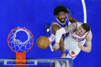 New York Knicks' Isaiah Hartenstein, right, goes up to shoot against Philadelphia 76ers' Joel Embiid, left, during the second half of Game 6 in an NBA basketball first-round playoff series, Thursday, May 2, 2024, in Philadelphia. (AP Photo/Matt Slocum)