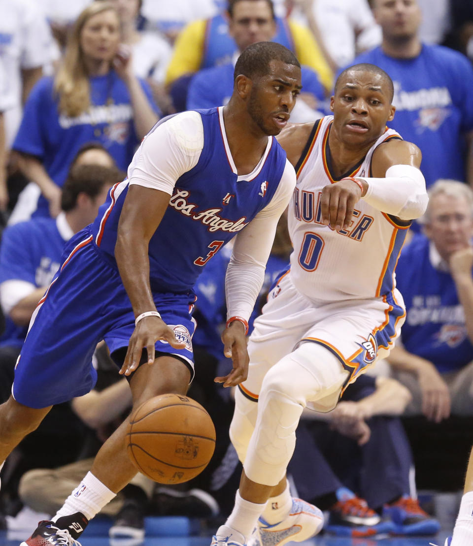 Los Angeles Clippers guard Chris Paul (3) drives in front of Oklahoma City Thunder guard Russell Westbrook (0) in the third quarter of Game 2 of the Western Conference semifinal NBA basketball playoff series in Oklahoma City, Wednesday, May 7, 2014. Oklahoma City won 112-101. (AP Photo/Sue Ogrocki)