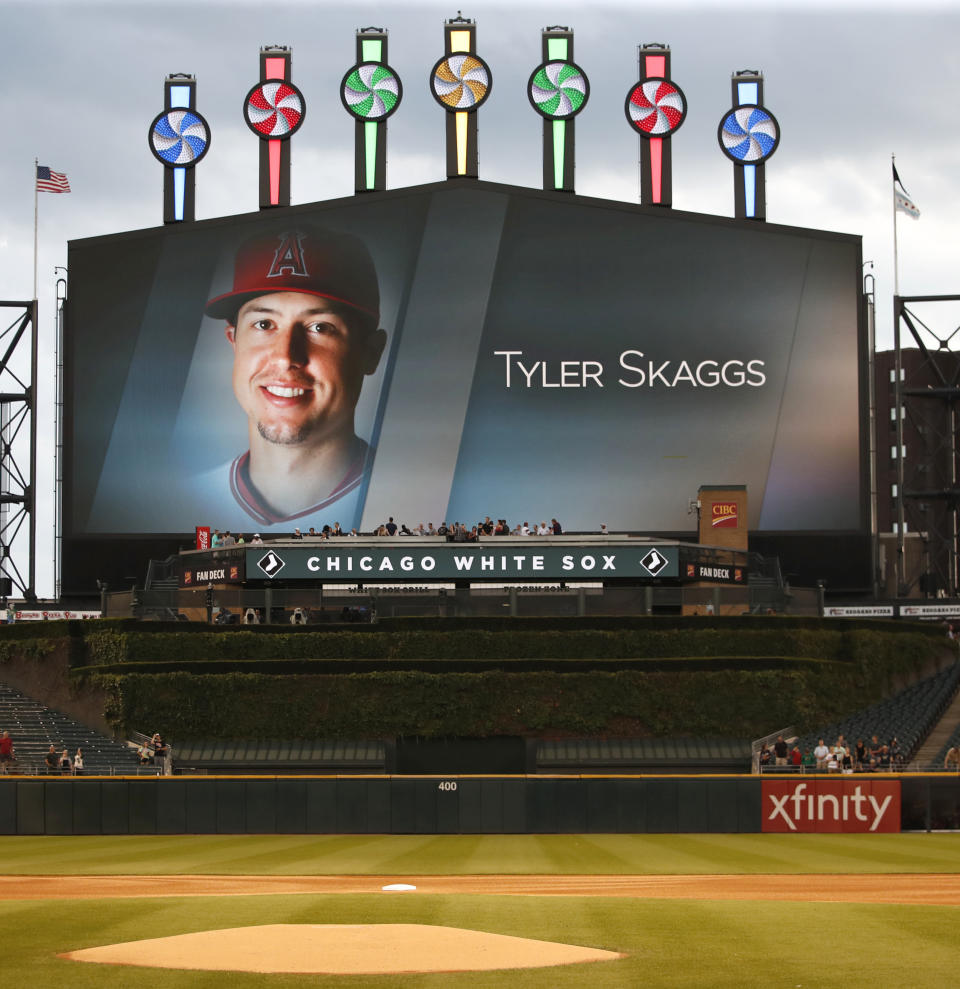 The Chicago White Sox have a moment of silence for Los Angeles Angels pitcher Tyler Skaggs, whose image is shown on the scoreboard. before a baseball game between the Detroit Tigers and the White Sox on Tuesday, July 2, 2019, in Chicago. Skaggs died Monday. (AP Photo/Jeff Haynes)