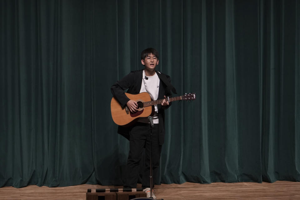 In this photo provided by Guo Jia, a businessman who runs a comedy club in Tokyo, Guo performs standup in Tokyo, Sunday, Nov. 6, 2022. (Courtesy of Guo Jia via AP)