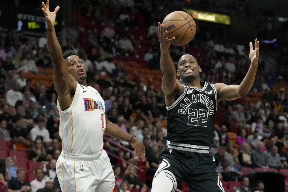 San Antonio Spurs guard Malaki Branham (22) goes for the ball as Miami Heat guard Kyle Lowry (7) defends during the first half of an NBA basketball game, Saturday, Dec. 10, 2022, in Miami. (AP Photo/Lynne Sladky)