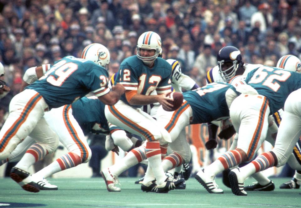 Jan 13, 1974; Houston, TX, USA; FILE PHOTO; Miami Dolphins quarterback Bob Griese (12) and running back Larry Csonka (39) in action against the Minnesota Vikings during Super Bowl VIII at Rice Stadium. Miami defeated Minnesota 24-7. Mandatory Credit: Dick Raphael-USA TODAY Sports