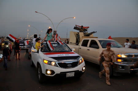 Iraqi people celebrate the liberation of the embattled city of Mosul, in Mosul, Iraq July 9, 2017. REUTERS/Stringer