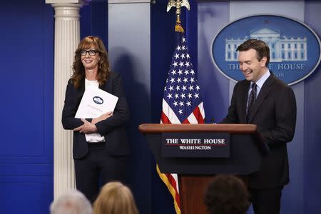 White House Press Secretary Josh Earnest (R) and actress Allison Janney, who played a fictional press secretary in "The West Wing" television show, stand together at the lectern before the daily press briefing at the White House in Washington, U.S., April 29, 2016. REUTERS/Jonathan Ernst