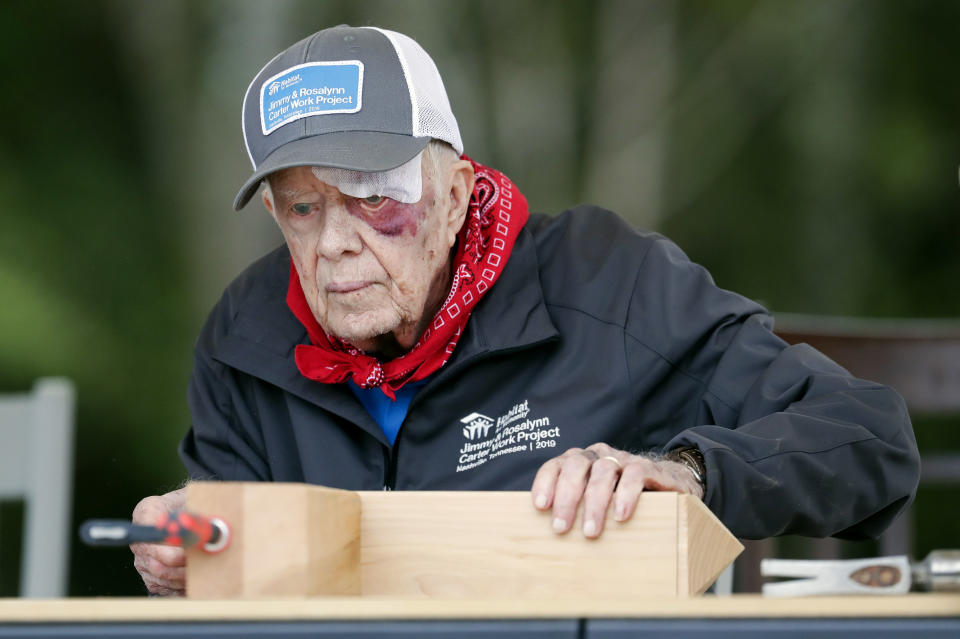 With a bandage above his left eye and a large, red welt below it, former President Jimmy Carter builds corbels at a Habitat for Humanity project Monday, Oct. 7, 2019, in Nashville, Tenn. Carter fell at home on Sunday, requiring 14 stitches, but he did not let his injuries keep him from participating in his 36th building project with the nonprofit Christian housing organization. He turned 95 last Tuesday, becoming the first U.S. president to reach that milestone. (AP Photo/Mark Humphrey)