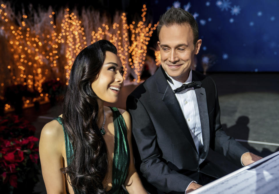 This image released by Netflix shows Aimee Garcia, left, and Freddie Prinze Jr. in a scene from "Christmas With You." (Jessica Kourkounis/Netflix via AP)