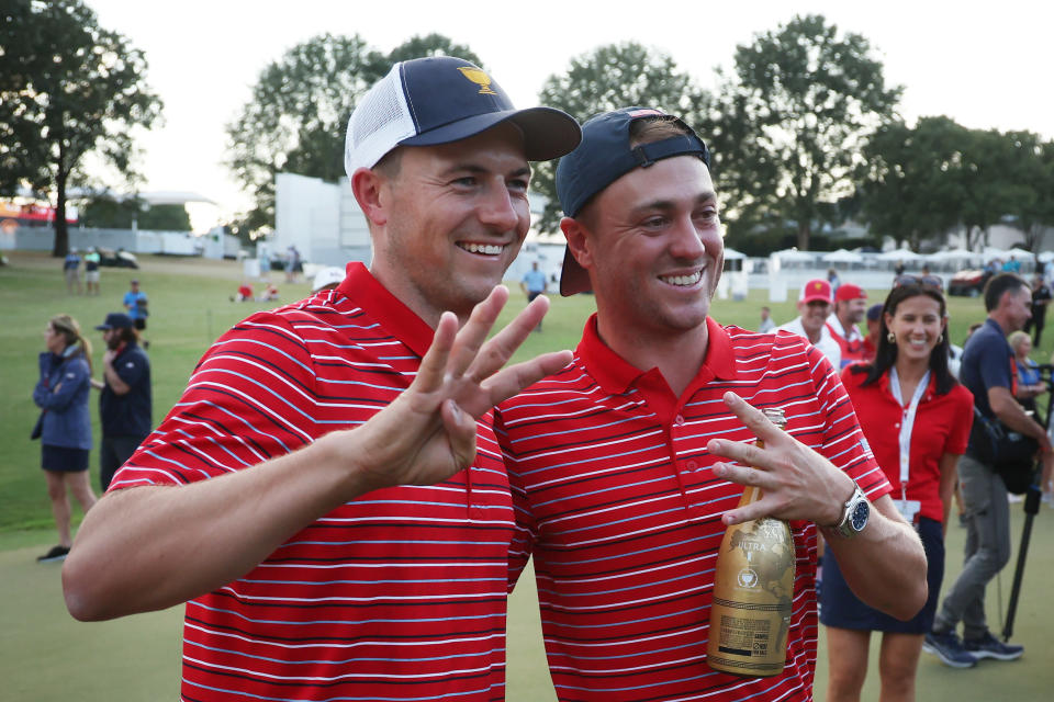 Jordan Spieth and Justin Thomas pose for a photo at the 2022 Presidents Cup holding up 4 fingers to show 4/4 wins