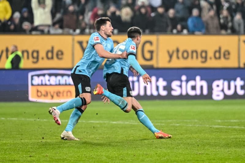 Leverkusen's Jonas Hofmann (L) and Exequiel Palacios (R) celebrate after the their side's first goal of the game during the German Bundesliga soccer match between FC Augsburg and Bayer Leverkusen at the WWK Arena. Harry Langer/dpa