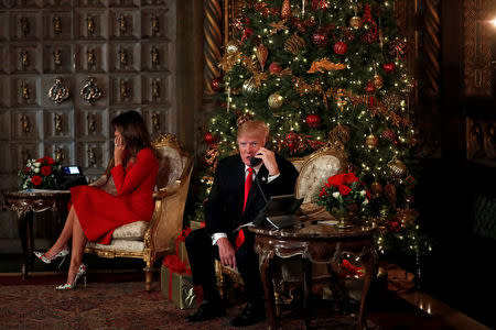 U.S. President Donald Trump and First Lady Melania Trump participate in NORAD (North American Aerospace Defense Command) Santa Tracker phone calls with children at Mar-a-Lago estate in Palm Beach, Florida, U.S., December 24, 2017. REUTERS/Carlos Barria