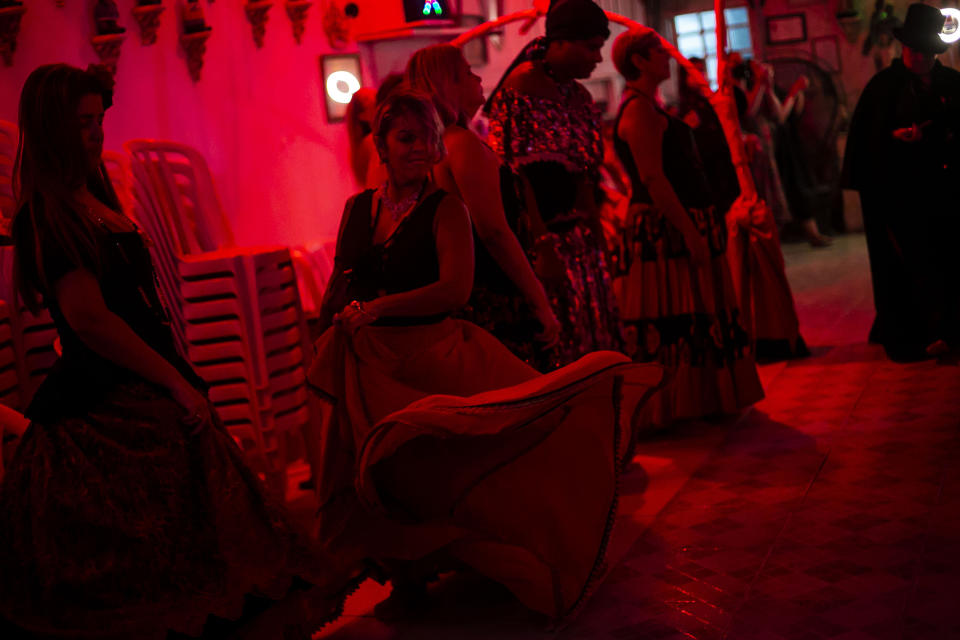 Devotees dance during an Umbanda religious ceremony at the Casa de Caridade Santa Barbara Iansa temple in Rio de Janeiro, Brazil, Saturday, Feb. 6, 2021. The faithful of the Umbanda religion, brought to America by West African slaves, perform spiritual protection rituals as part of pre-Carnival traditions. (AP Photo/Bruna Prado)