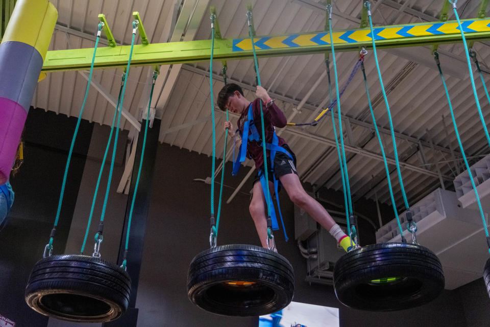 A young boy does some high flying climbing on the overhead course  at Urban Air Adventure Park in Amarillo.
