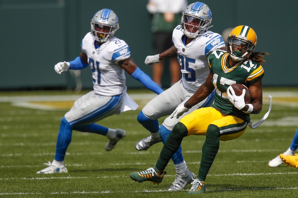 Green Bay Packers' Davante Adams tries to get away from Detroit Lions' Will Harris during the first half of an NFL football game Sunday, Sept. 20, 2020, in Green Bay, Wis. (AP Photo/Matt Ludtke)