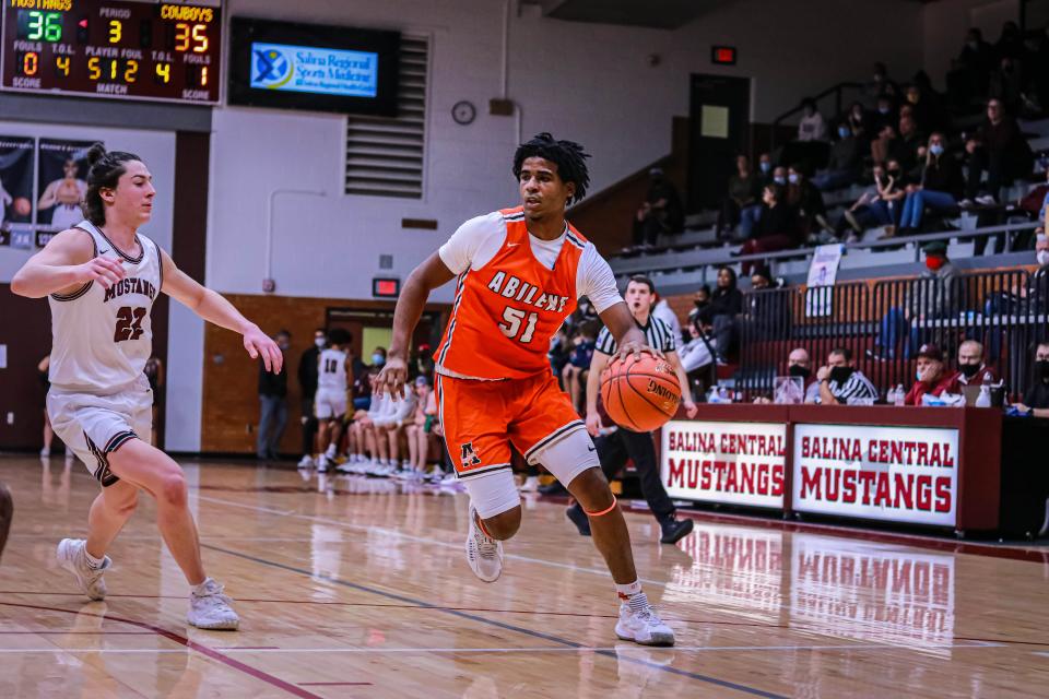 Abilene’s Thomas McClendon dribbles up the left wing guarded by Salina Central’s Parker Kavanagh (22) in Thursday’s game at Central gym.