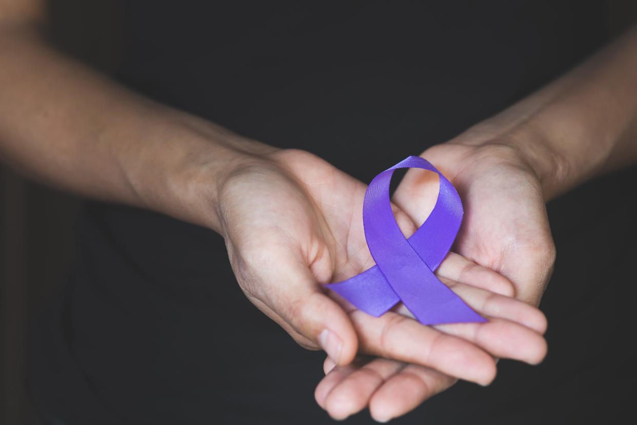 A purple ribbon signifies domestic violence awareness.
