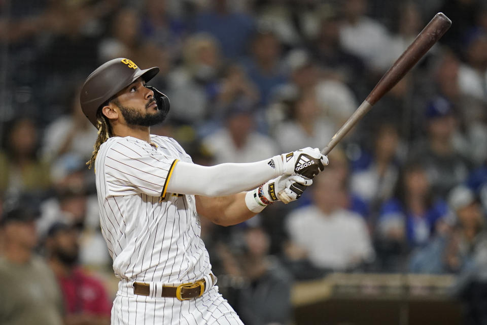 San Diego Padres' Fernando Tatis Jr. watches his two-run home run hit during the fifteenth inning of a baseball game against the Los Angeles Dodgers, Thursday, Aug. 26, 2021, in San Diego. (AP Photo/Gregory Bull)